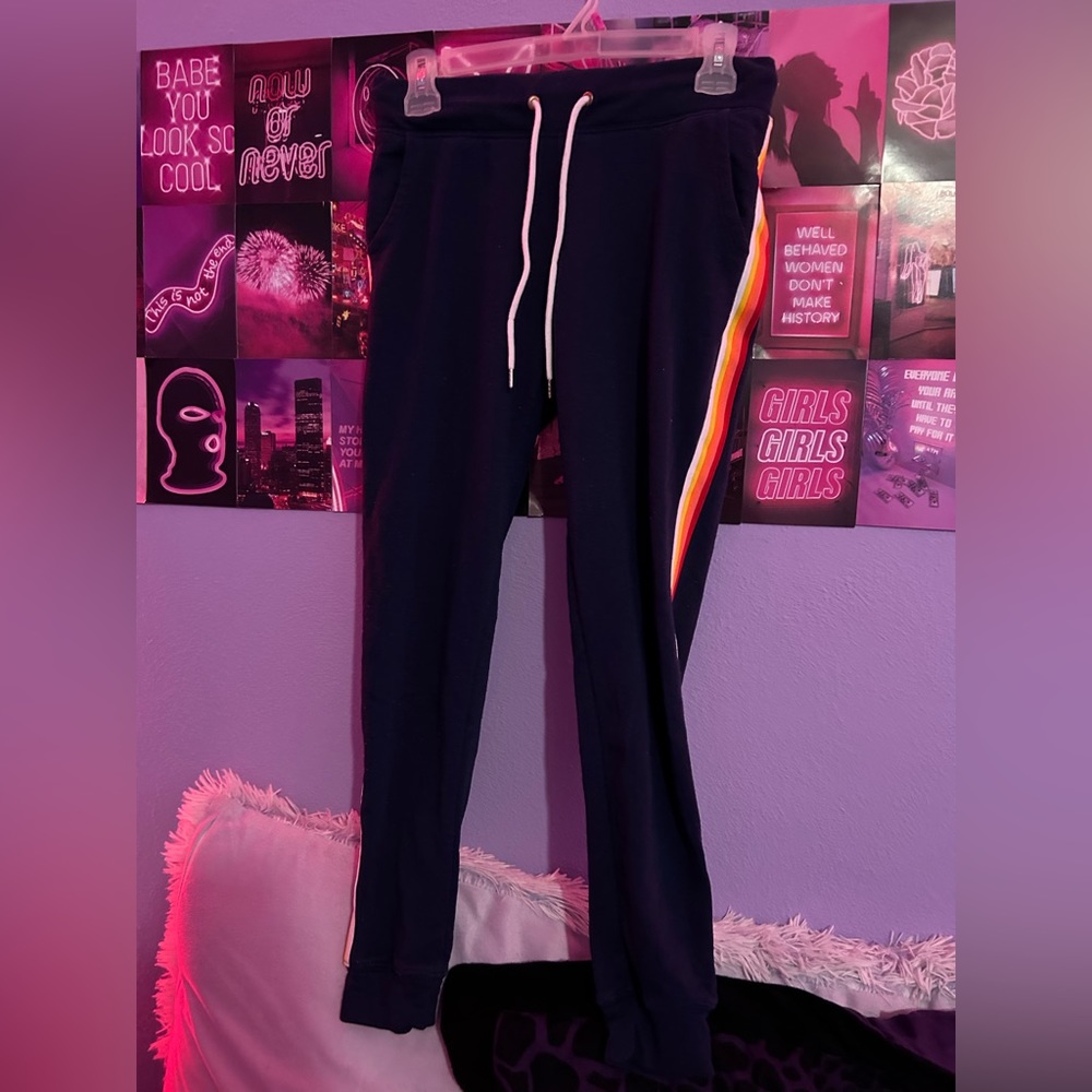 black sweatpants with red, orange, yellow, and white stripes on the sides